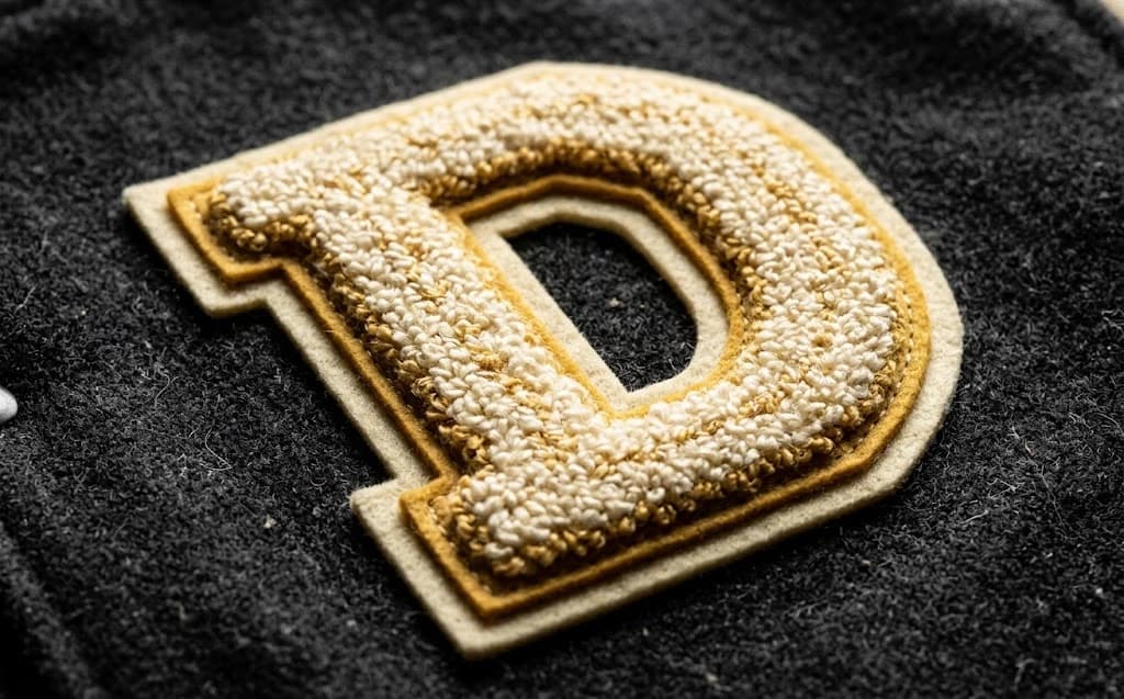 3D heavyweight chenille dance letter patch with double felt base on a wool team varsity jacket